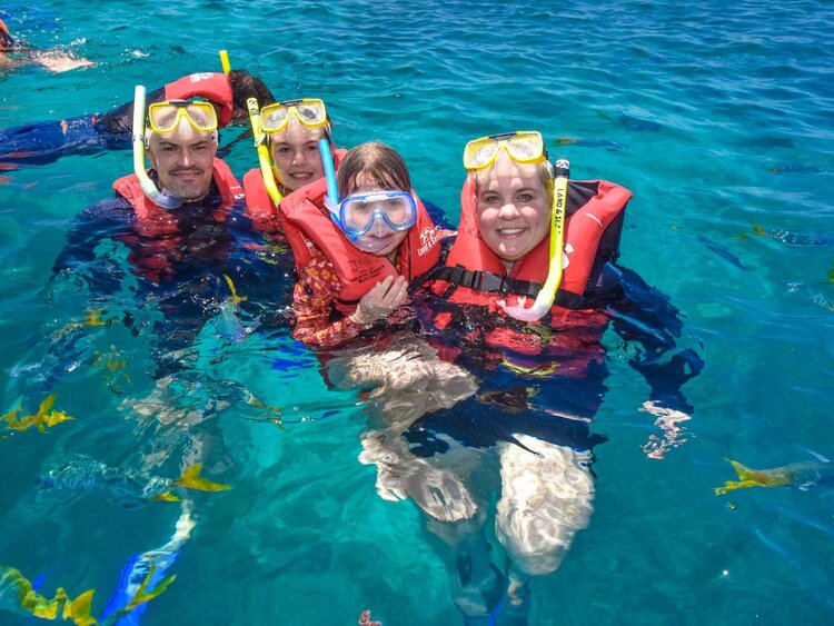 Family snorkelling on the Great Barrier Reef